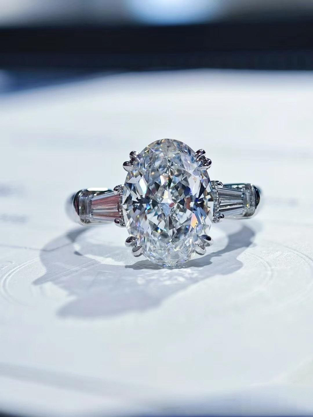 Classic Winston Oval-Shaped Engagement Ring with Tapered Baguette Side Stones